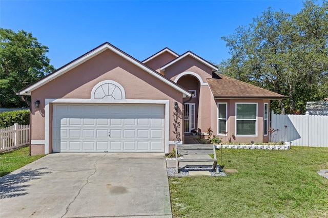9301 Echo Run, Orlando, FL 32817 - view of front of property featuring driveway, an attached garage, and stucco siding