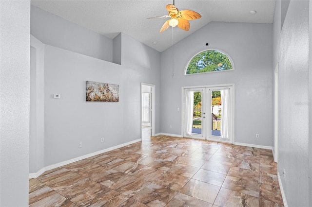 9301 Echo Run, Orlando, FL 32817 - spare room featuring ceiling fan, high vaulted ceiling, french doors, marble look tiles, and baseboards