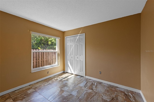 9301 Echo Run, Orlando, FL 32817 - unfurnished bedroom with baseboards, a closet, and a textured ceiling
