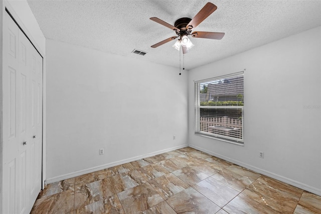 9301 Echo Run, Orlando, FL 32817 - unfurnished bedroom with a textured ceiling, a closet, baseboards, and a ceiling fan