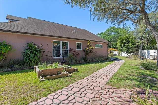 9301 Echo Run, Orlando, FL 32817 - back of property with a vegetable garden and stucco siding
