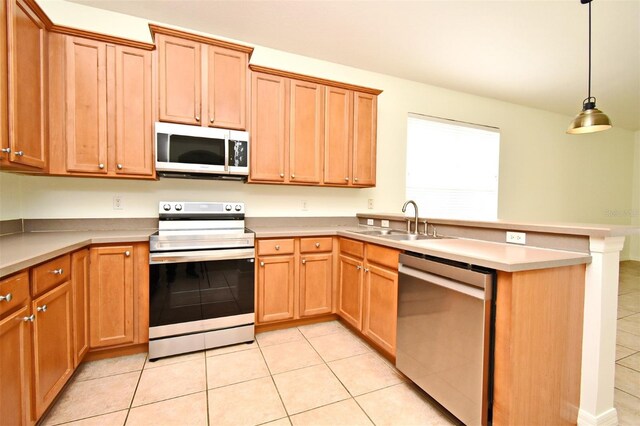 4626 Redmond Pl, Sanford, FL 32771 - kitchen with a peninsula, light countertops, appliances with stainless steel finishes, pendant lighting, and a sink