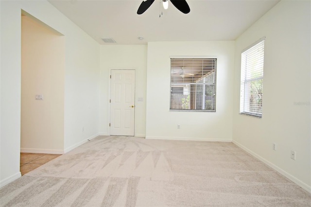 4626 Redmond Pl, Sanford, FL 32771 - spare room featuring light colored carpet, baseboards, a ceiling fan, and visible vents