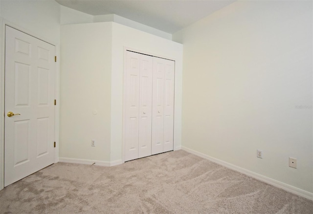 4626 Redmond Pl, Sanford, FL 32771 - unfurnished bedroom featuring a closet, light colored carpet, and baseboards