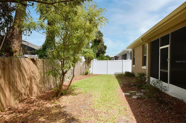 4626 Redmond Pl, Sanford, FL 32771 - view of yard featuring a sunroom and a fenced backyard
