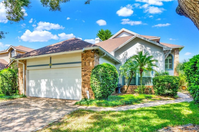 738 Powderhorn Cir, Lake Mary, FL 32746 - view of front of property featuring a garage, a chimney, stucco siding, driveway, and roof with shingles