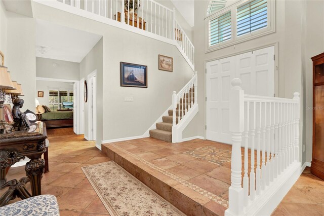738 Powderhorn Cir, Lake Mary, FL 32746 - entryway with stairs, a high ceiling, and baseboards
