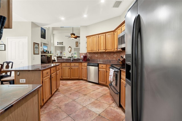 738 Powderhorn Cir, Lake Mary, FL 32746 - kitchen with a peninsula, a ceiling fan, visible vents, appliances with stainless steel finishes, and backsplash