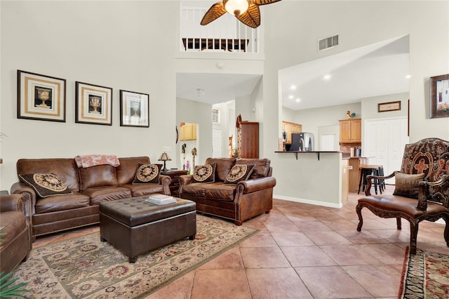 738 Powderhorn Cir, Lake Mary, FL 32746 - living room featuring visible vents, baseboards, light tile patterned floors, ceiling fan, and a towering ceiling