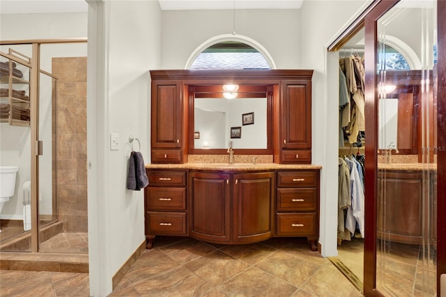 738 Powderhorn Cir, Lake Mary, FL 32746 - full bathroom featuring a walk in closet, tile patterned flooring, a shower stall, and vanity