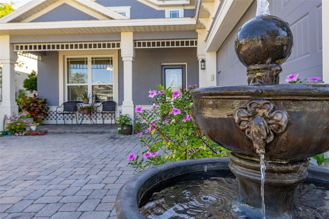 7837 Bostonian Dr, Winter Garden, FL 34787 - view of exterior entry with stucco siding and a porch