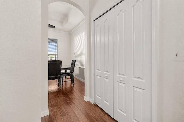 7837 Bostonian Dr, Winter Garden, FL 34787 - corridor featuring dark wood-style flooring, arched walkways, ornamental molding, and baseboards