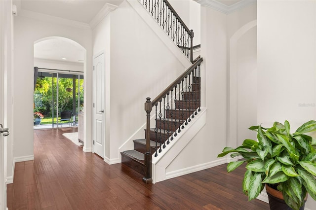 7837 Bostonian Dr, Winter Garden, FL 34787 - stairs featuring baseboards, arched walkways, hardwood / wood-style floors, and ornamental molding