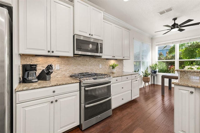 7837 Bostonian Dr, Winter Garden, FL 34787 - kitchen with visible vents, ornamental molding, dark wood-style floors, a ceiling fan, and stainless steel appliances