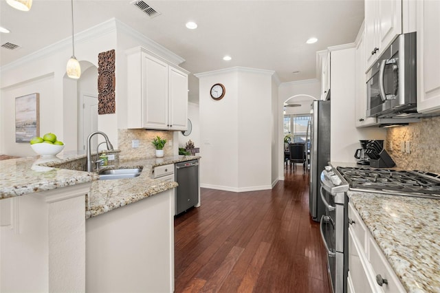 7837 Bostonian Dr, Winter Garden, FL 34787 - kitchen with visible vents, a sink, recessed lighting, arched walkways, and stainless steel appliances