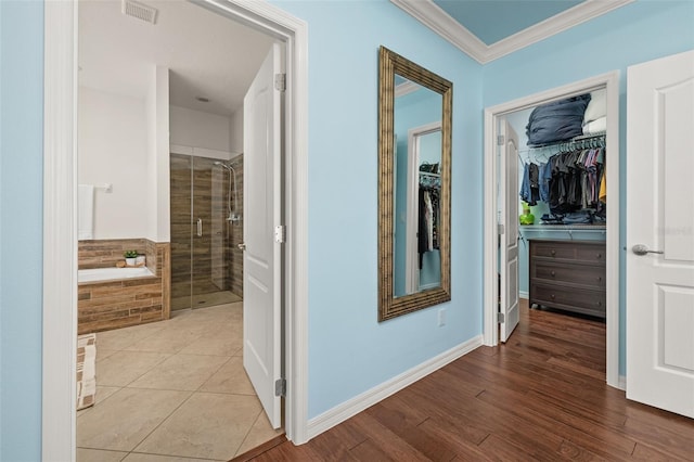 7837 Bostonian Dr, Winter Garden, FL 34787 - hall featuring baseboards, visible vents, ornamental molding, and wood finished floors
