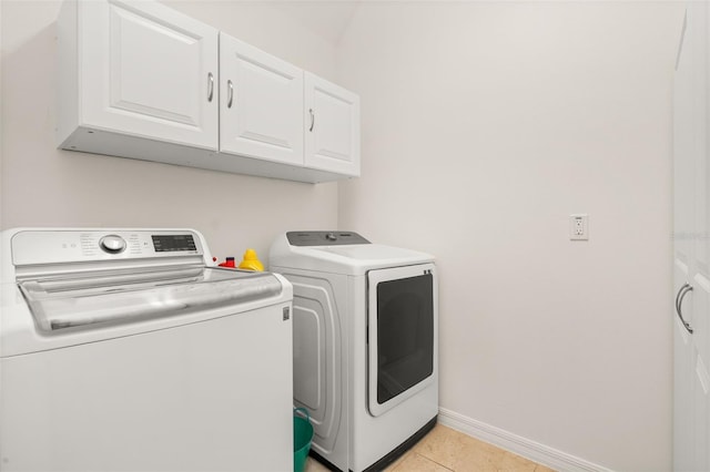 7837 Bostonian Dr, Winter Garden, FL 34787 - washroom featuring baseboards, cabinet space, independent washer and dryer, and light tile patterned floors