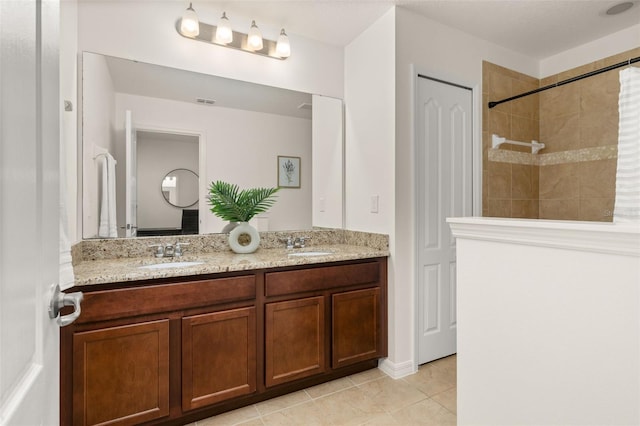 7837 Bostonian Dr, Winter Garden, FL 34787 - full bath with a sink, tile patterned floors, tiled shower, and double vanity