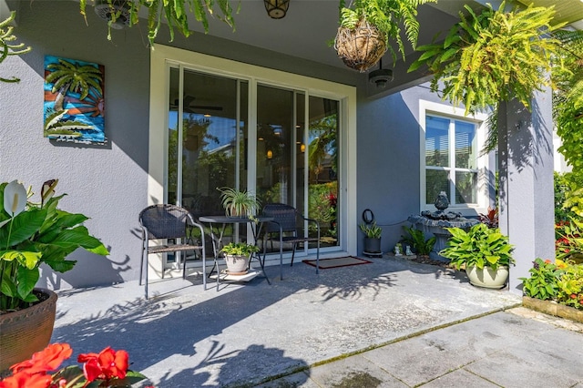 7837 Bostonian Dr, Winter Garden, FL 34787 - property entrance featuring a patio and stucco siding