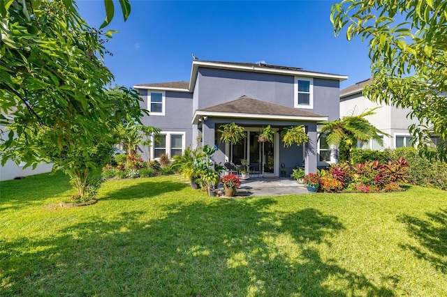 7837 Bostonian Dr, Winter Garden, FL 34787 - rear view of property with a patio, roof mounted solar panels, stucco siding, and a lawn