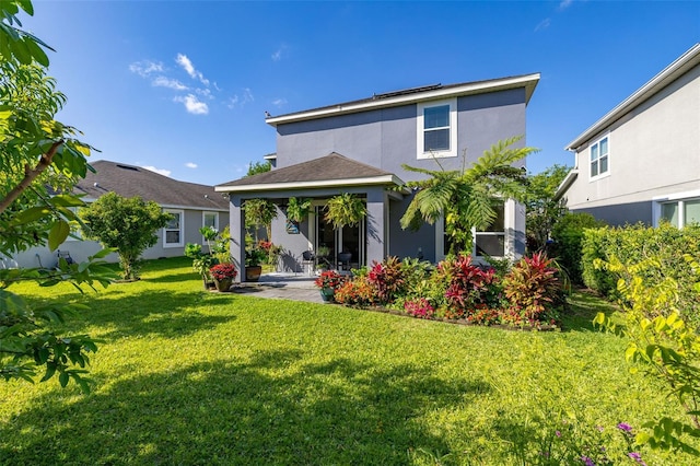 7837 Bostonian Dr, Winter Garden, FL 34787 - rear view of property with a patio, stucco siding, a yard, and solar panels