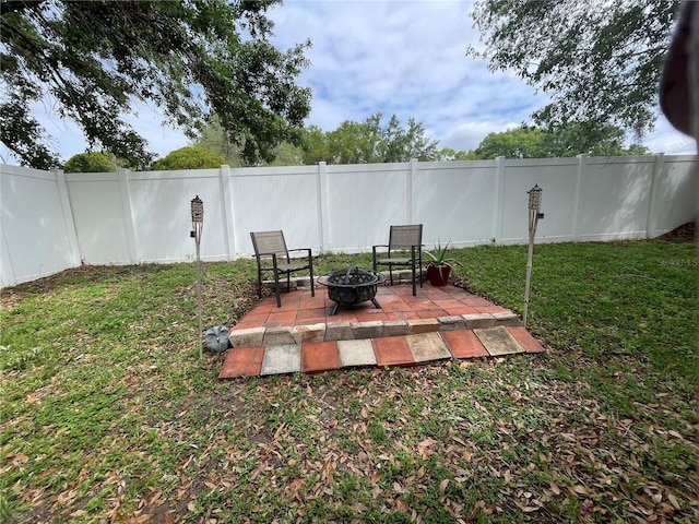 view of yard with an outdoor fire pit, a patio area, and a fenced backyard