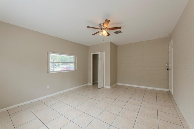 empty room with visible vents, ceiling fan, and light tile patterned flooring