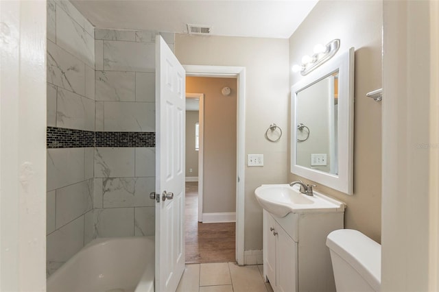 full bath featuring visible vents, baseboards, toilet, shower / bathing tub combination, and vanity