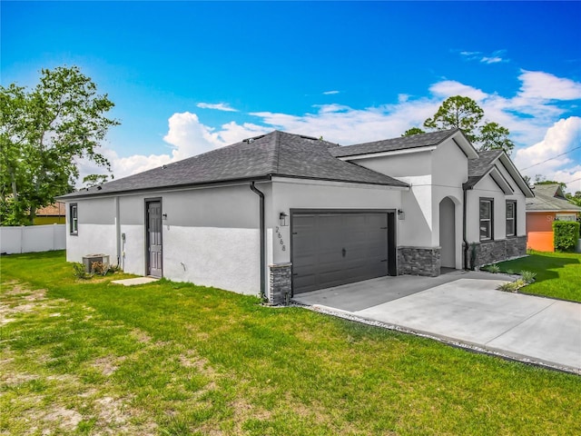 view of front facade with stucco siding, driveway, stone siding, an attached garage, and a front yard