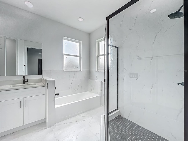 bathroom with a marble finish shower, marble finish floor, vanity, and a garden tub