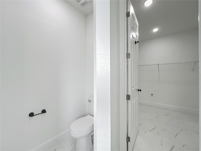 bathroom with visible vents, marble finish floor, baseboards, and toilet
