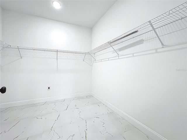 spacious closet with marble finish floor