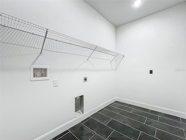 laundry room featuring laundry area, hookup for an electric dryer, washer hookup, and baseboards