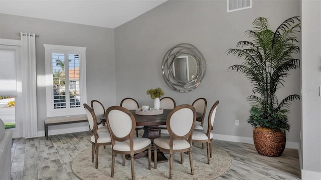 dining space with visible vents, baseboards, and wood finished floors