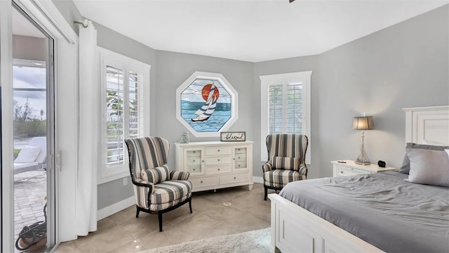 bedroom with access to exterior, baseboards, and light tile patterned flooring