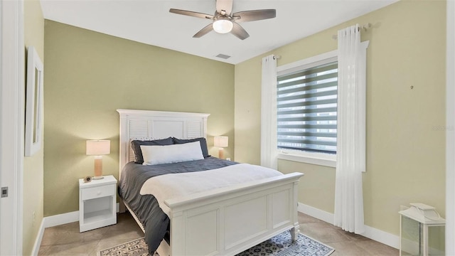 bedroom featuring light tile patterned floors, baseboards, a ceiling fan, and visible vents