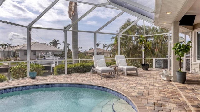 pool featuring a patio and glass enclosure