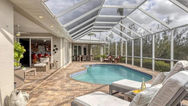 outdoor pool with an outdoor living space, a patio area, and a ceiling fan