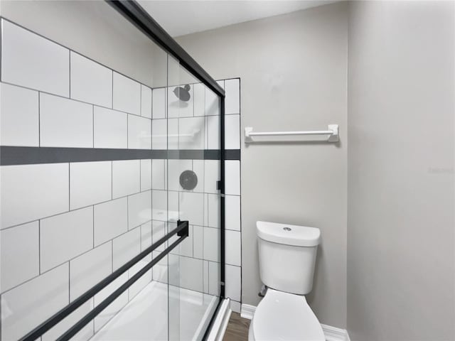 full bathroom with a shower stall and toilet