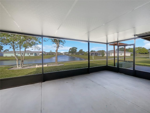 unfurnished sunroom with a water view