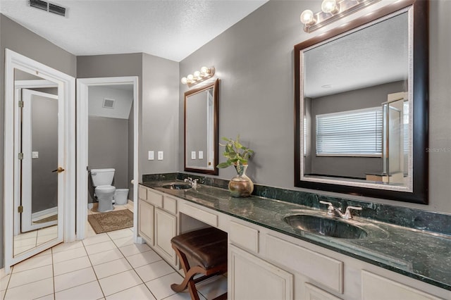 full bathroom with visible vents, a textured ceiling, and a sink