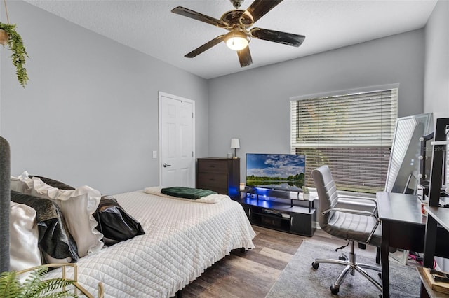 bedroom featuring a ceiling fan and wood finished floors