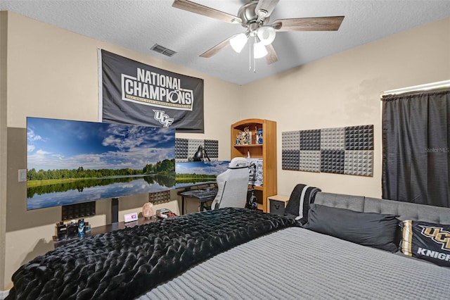 bedroom with visible vents, ceiling fan, and a textured ceiling