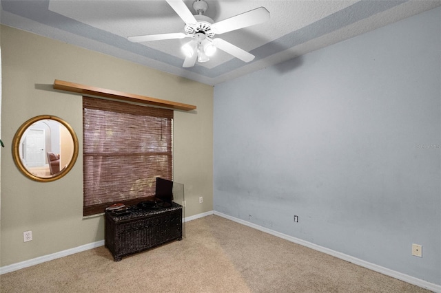 interior space featuring carpet flooring, baseboards, and a ceiling fan