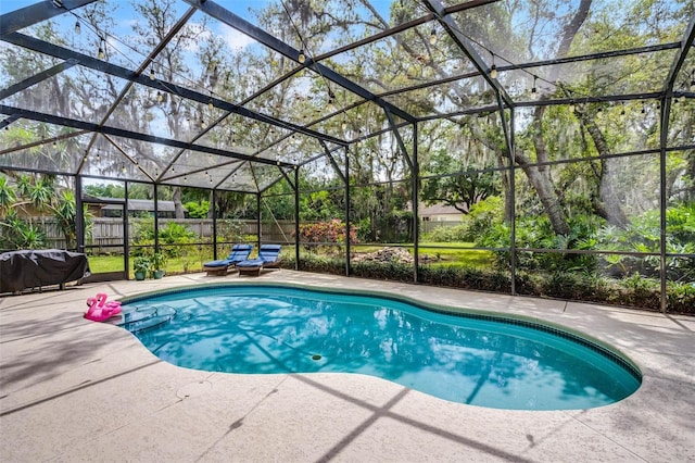 view of swimming pool featuring a patio area, fence, a fenced in pool, and glass enclosure