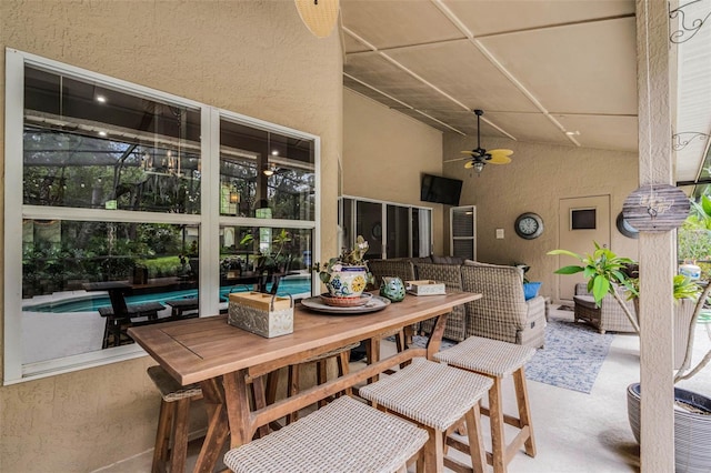 view of patio with an outdoor pool, outdoor dining space, and ceiling fan