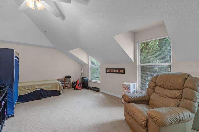 carpeted bedroom featuring ceiling fan, baseboards, and lofted ceiling