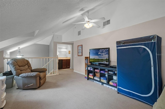 sitting room with ceiling fan, a textured ceiling, carpet flooring, an upstairs landing, and lofted ceiling