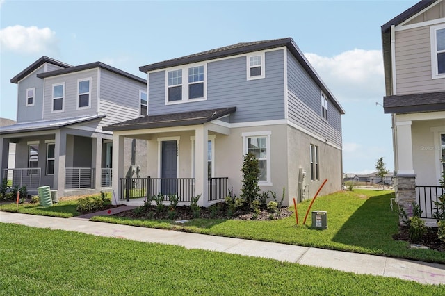 16484 Silver Brook Way, Winter Garden, FL 34787 - view of front facade featuring covered porch, a front lawn, stucco siding, and roof with shingles