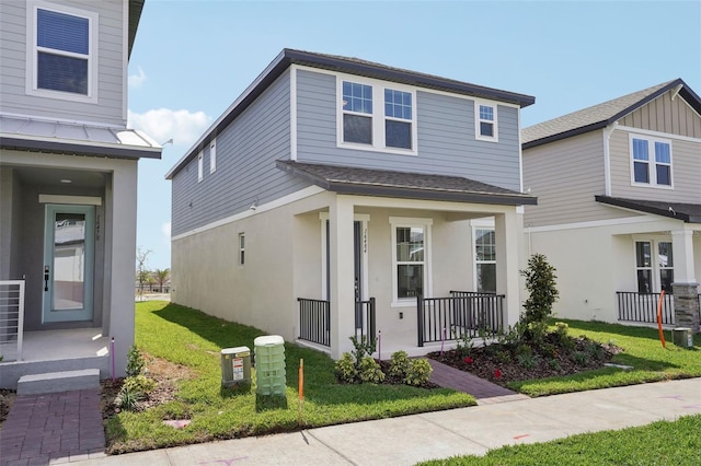 16484 Silver Brook Way, Winter Garden, FL 34787 - view of front of house featuring a porch, a front lawn, stucco siding, and a shingled roof